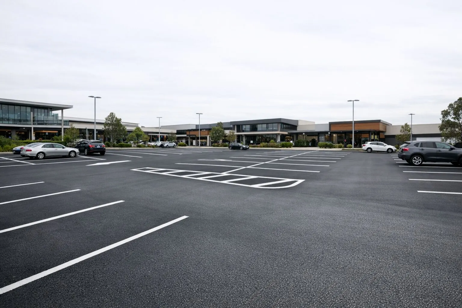 A freshly resurfaced commercial asphalt car park with clean line marking