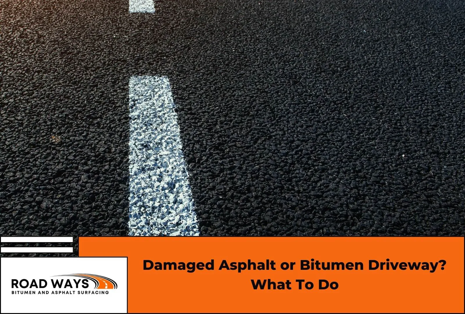 A damaged asphalt driveway showing cracks in need of repair