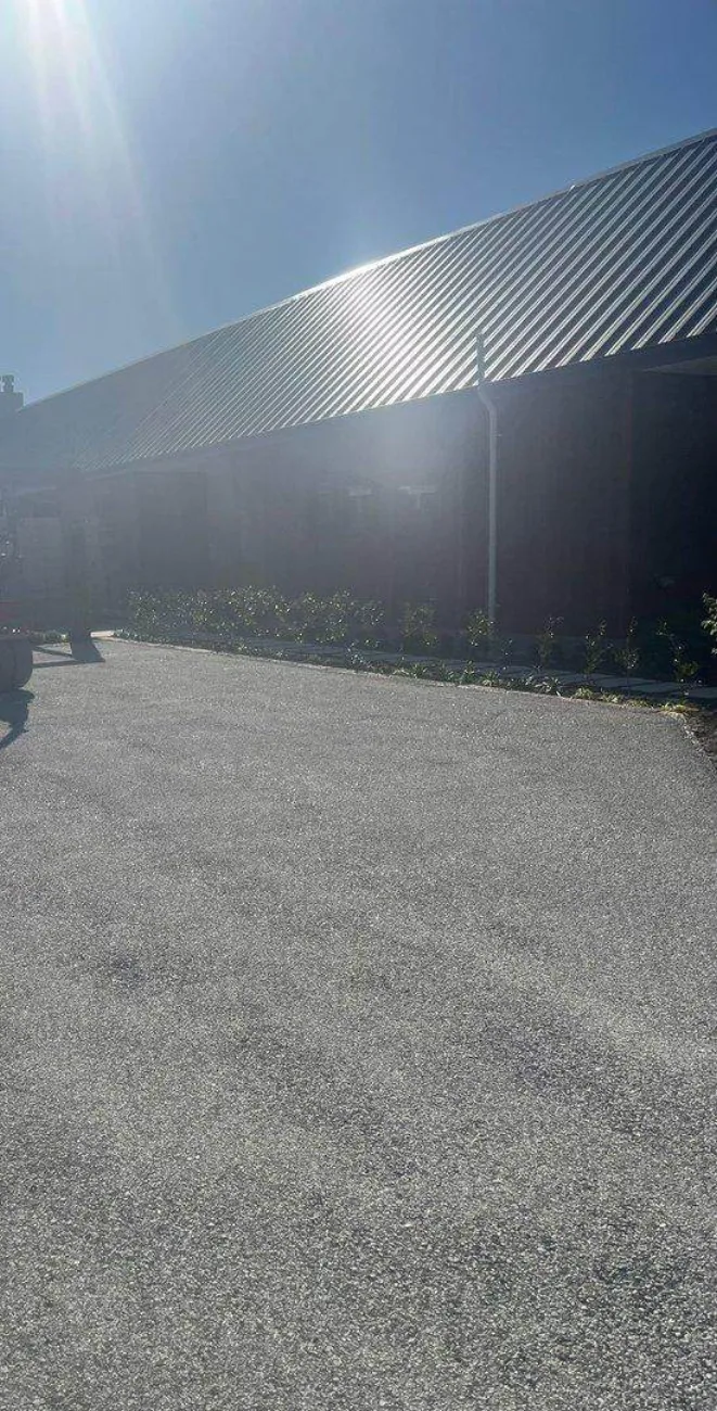 A freshly sealed commercial yard on a Road Ways job