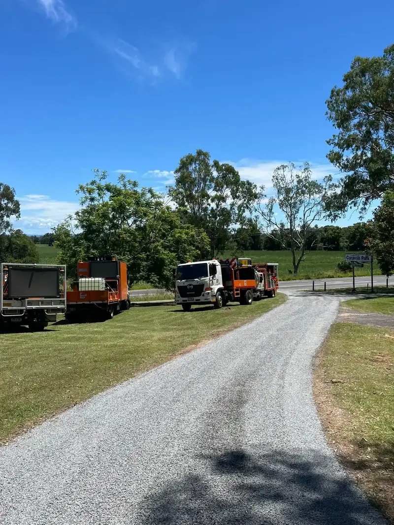 Trucks parked along a rural driveway