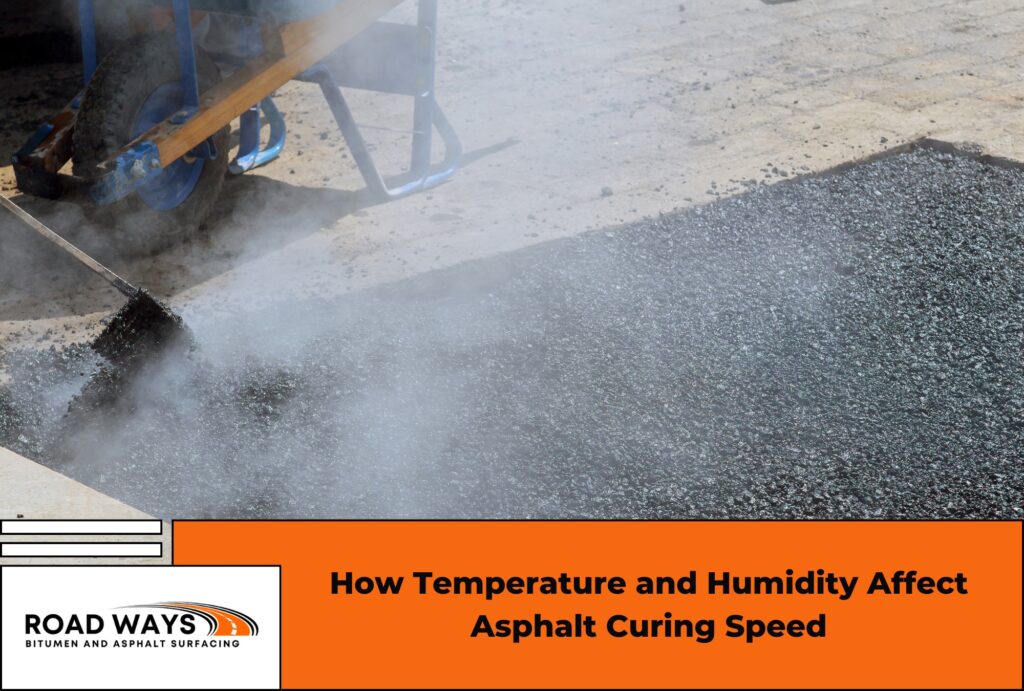 A road paving machine laying hot mix asphalt on a new road surface on a clear day, showing the steam rising from freshly laid material
